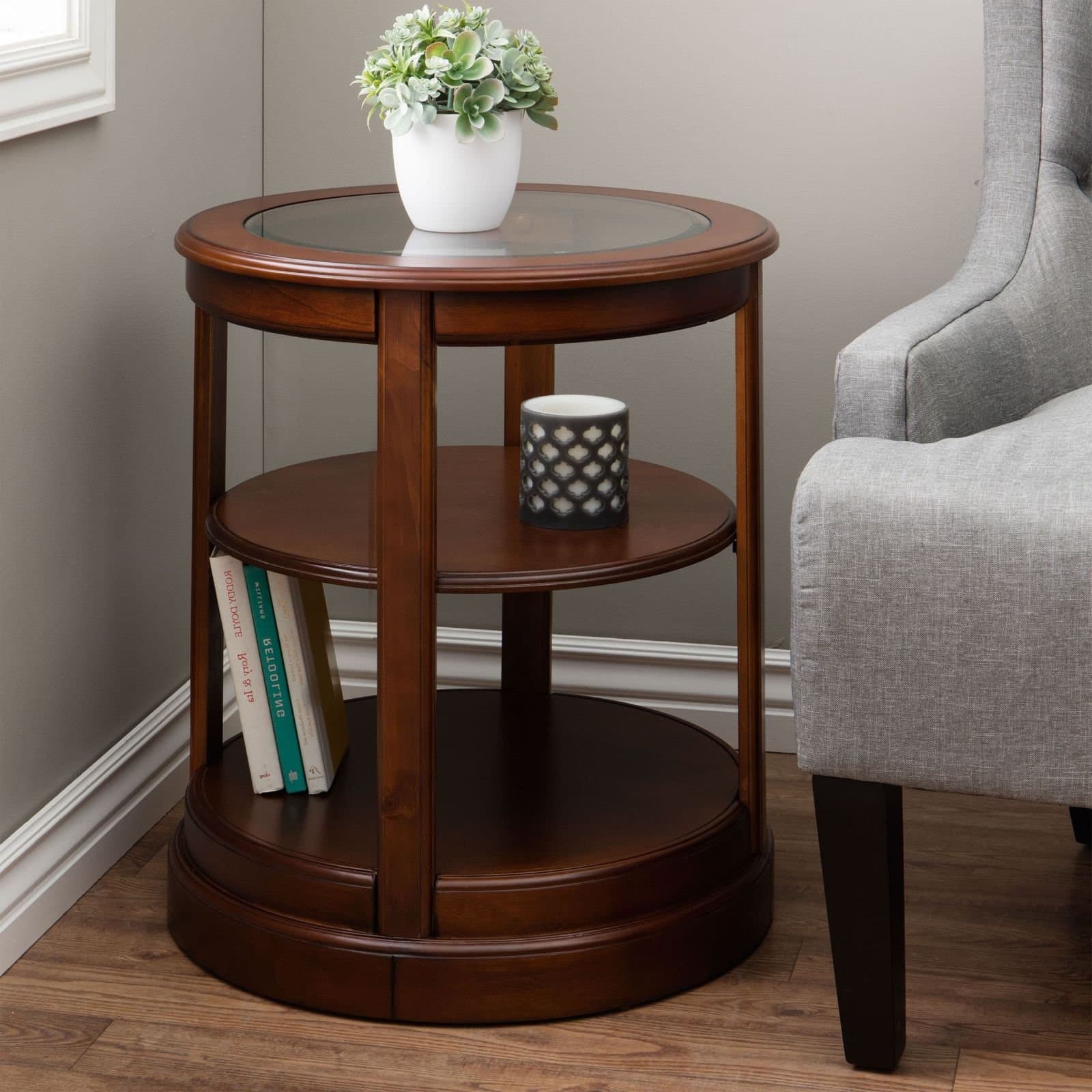 Open End Table Provides Classic Style and Contemporary Function. 22-Inch Round Side Piece Features A Glass Top Shelf and Two Lower Storage Shelves. Walnut Brown Wood Table Suitable for Living Rooms